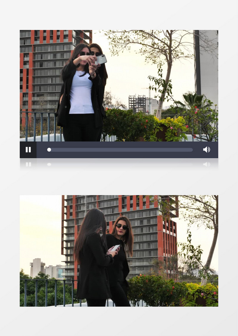 两个黑发美女在拿手机自拍实拍视频素材