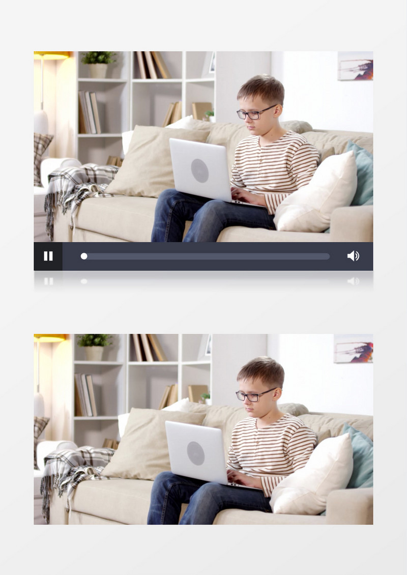 戴眼镜的小男孩坐在沙发上玩电脑实拍视频素材