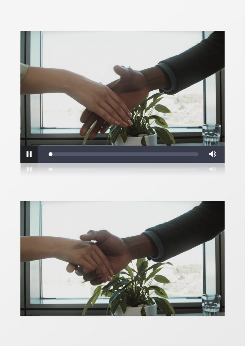 两个白领在窗前握手实拍视频素材