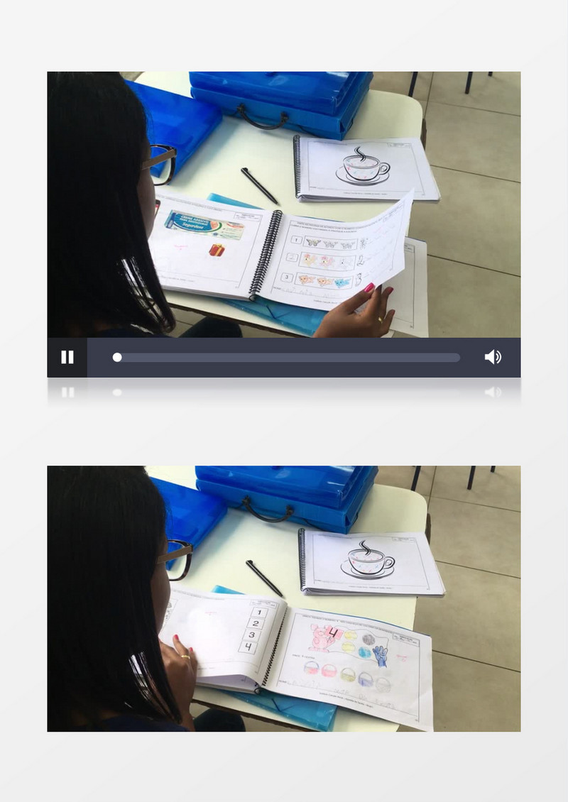 老师在翻看学生的绘画作业实拍视频素材