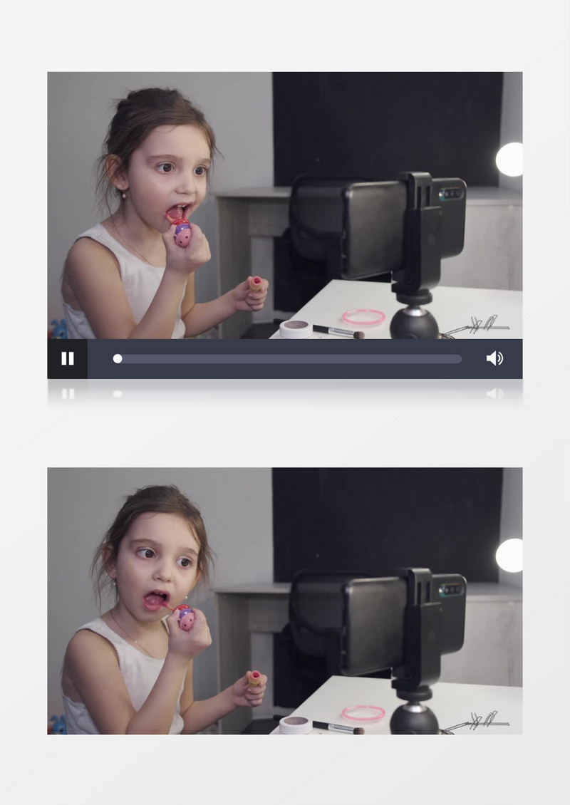 小女孩对着手机在涂彩色唇彩实拍视频素材