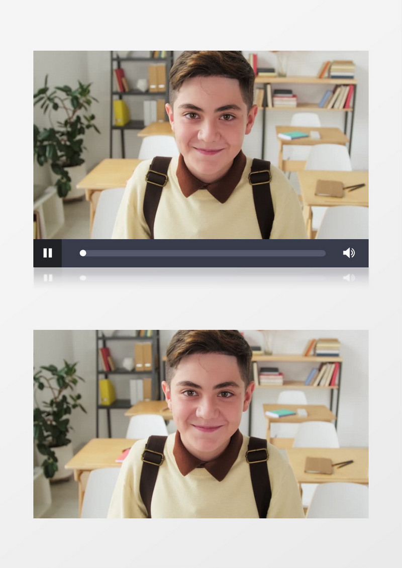 一个男孩坐在课桌上背着书包微笑实拍视频素材