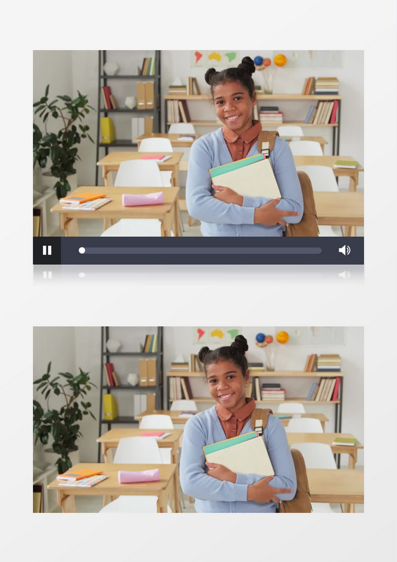一个女孩站在课桌旁边抱着书本微笑实拍视频素材