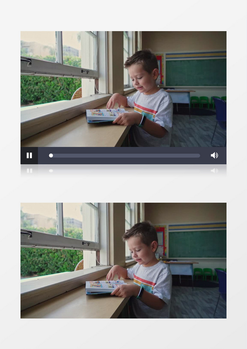 小男孩坐在窗边看书实拍视频素材