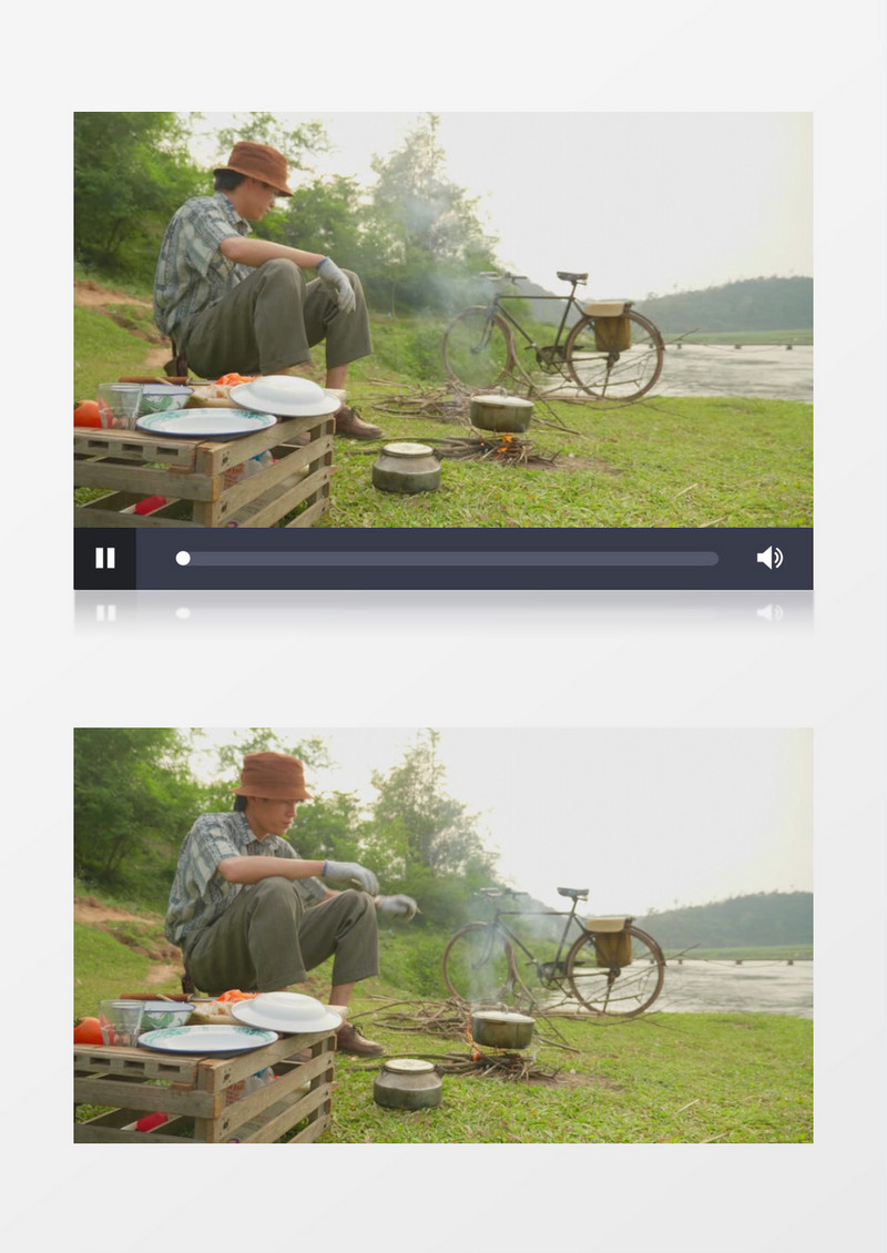 男人坐在河边的草地上野炊实拍视频素材