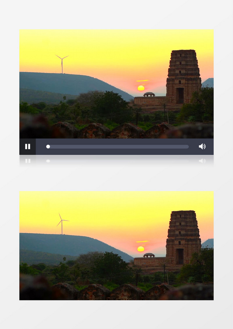 夕阳照耀着古塔和山坡上转动的风车实拍视频素材