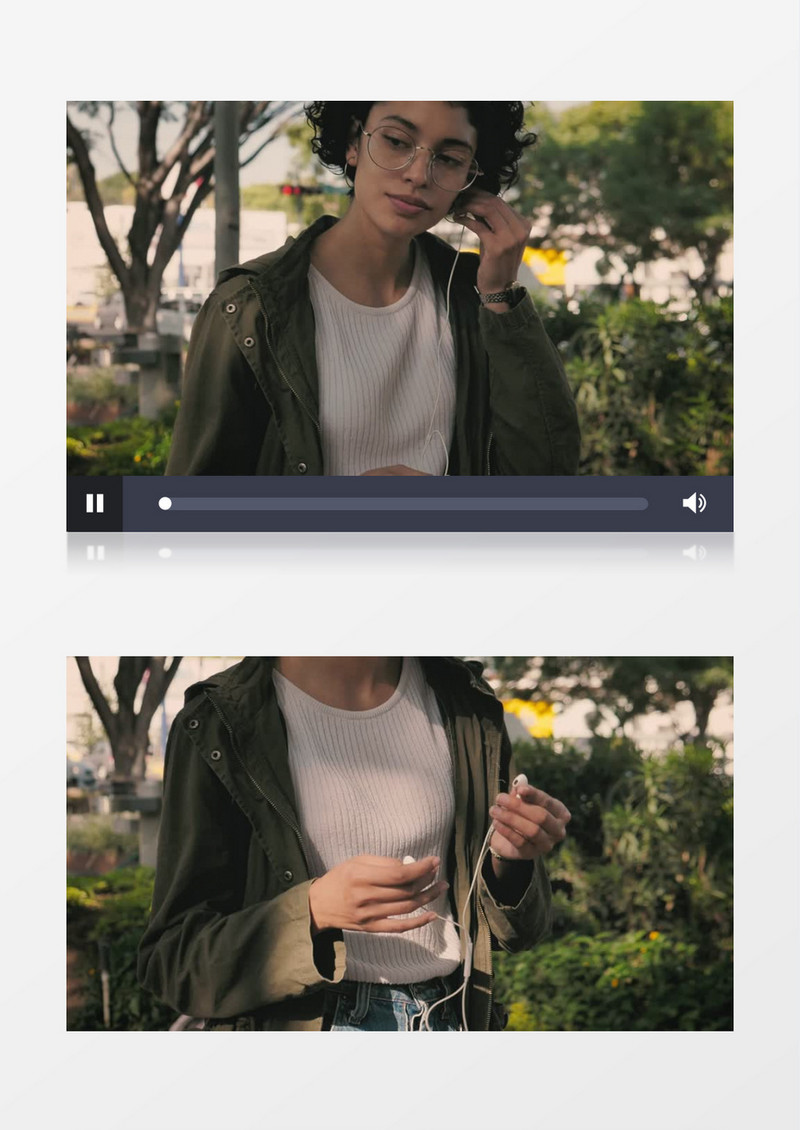 身穿绿色衣服的女子边走边戴耳机实拍视频素材