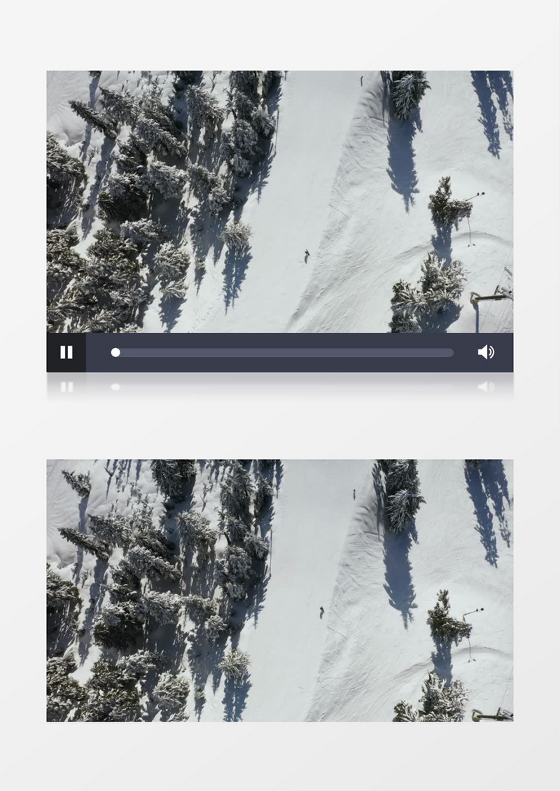 航拍一个滑雪者从松树覆盖的雪坡上滑下实拍视频素材