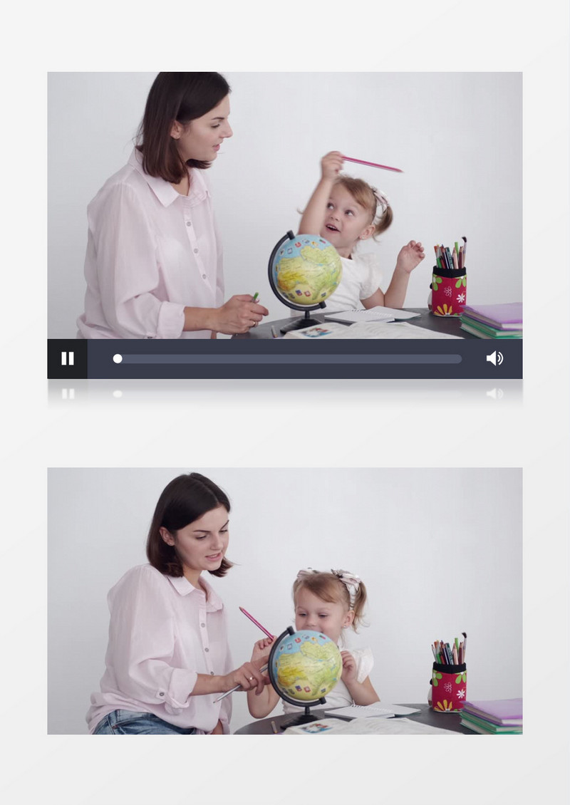 妈妈在教小女孩认识地球仪的颜色实拍视频素材
