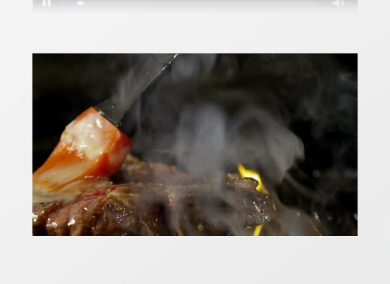 一块牛排在火上烹饪实拍视频素材