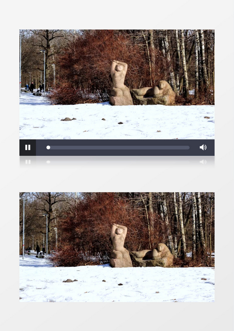雪林里有两个雕像以及树林中玩耍的人群实拍视频素材
